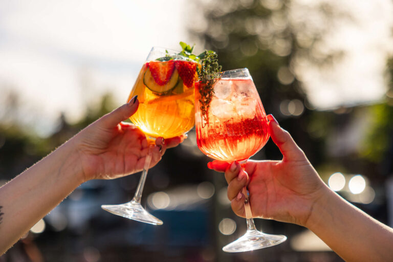 Pimms Fizz spritz cheers in the golden glow light of the evening